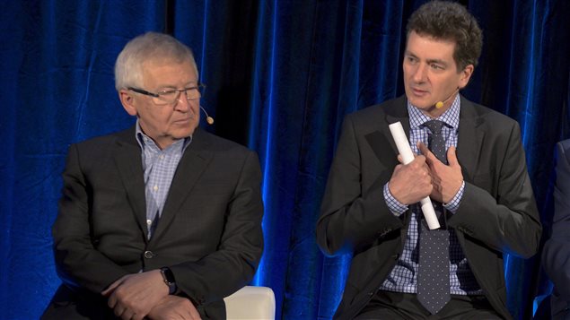  Jean-Pierre Leger, St-Hubert’s chairman and CEO and a member of the company’s founding family, left, listens as Bill Gregson, chief executive officer of Cara, speaks to reporters in Montreal Thursday, March 31, 2016. 