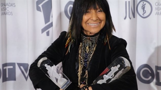 Buffy Sainte-Marie with her two Junos, one for Aboriginal Album of the Year and another for Contemporary Roots Album of the Year.
