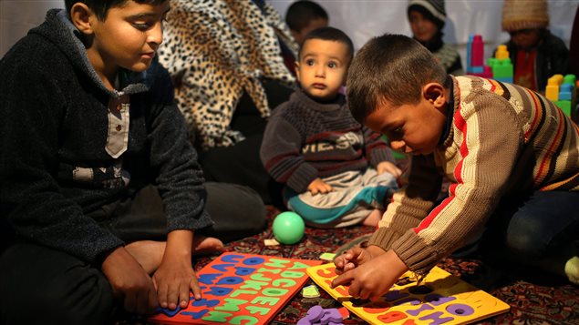 Syrian refugee children have a lesson in a refugee camp in the eastern Bekaa valley in Lebanon in March 2014. Canada’s minister of international development said today “we cannot afford to lose the potential of an entire generation of young Syrians” for a lack of education and opportunities.