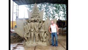 Artist Tim Schmalz with the clay model of one of his military memorials