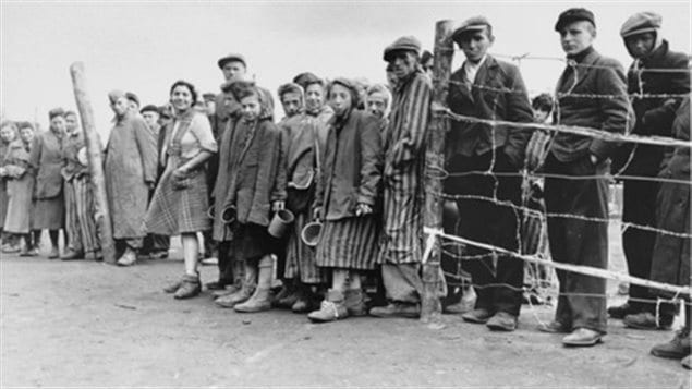 Soon after liberation, camp survivors await their ration of potato soup. Bergen-Belsen, Germany, April 28, 1945.