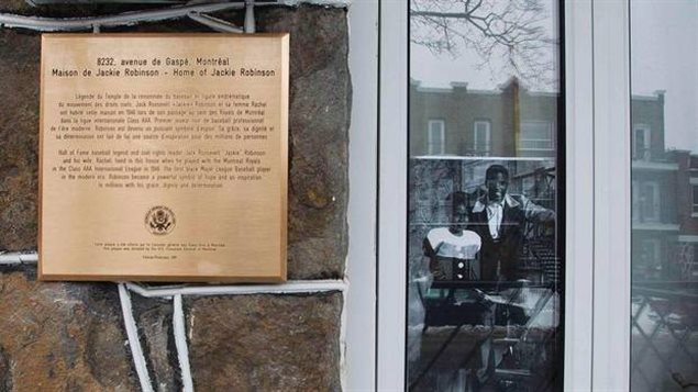 A photo of late baseball player Jackie Robinson and his wife Rachel sits in a window beside a plaque outside the former residence of Jackie Robinson placed there by the US Embassy in Montreal, February 28, 2011.(CHRISTINNE MUSC