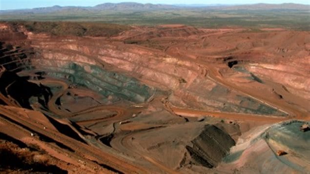 Open pit iron mine in Gabon. Cutting into the rock revealed the striations shown in the main photo