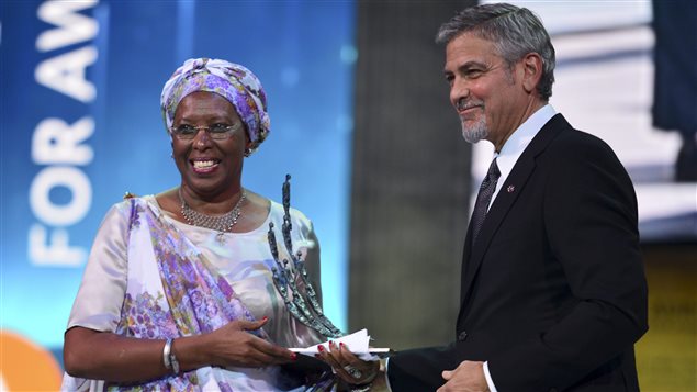  US Actor George Clooney, right, presents the first Aurora Prize, an award recognizing an individual’s work to advance humanitarian causes, to Marguerite Barankitse, left, during an awarding ceremony in Yerevan, Armenia, Sunday, April 24, 2016. Barankitse saved thousands of lives and cared for orphans and refugees amid the Burundi civil war. Armenian philanthropists selected her for the award. 