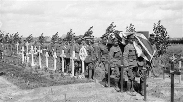 A Canadian military funeral at a cemetery at Poperinghe, Belgium, 11 August 1917. Many of the temporary cemetaries would be lost in ensuing battles as the front moved back and forth over the same ground. Helmer’s grave is among the lost.