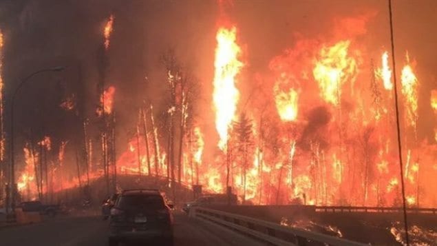 A view of the drive out of Fort McMurray amid the wildfire on Tuesday.  Drivers on an acess road leading to a highway below heading out of town. Drivers said even inside their cars they could feal the intense heat.