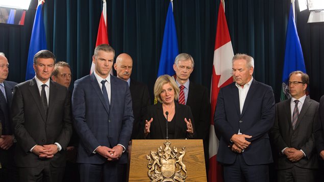  Premier Rachel Notley speaks to the media along with Suncor President and CEO Steve Williams, right, and President and CEO Canadian Association of Petroleum Producers Tim McMillan, left, at the Alberta Legislature in Edmonton, Alberta, on Tuesday, May 10, 2016.