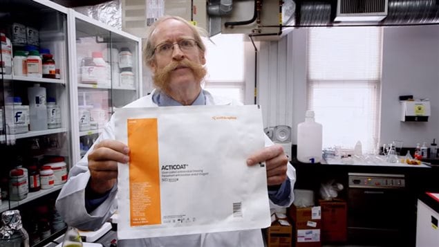 Professor Burrell, University of Alberta, Canada Research Chair in Nanostructured Biomaterials and winner of one of Canada’s first Governor General’s Innovation Awards, holding his invention of an *Acticoat* wound dressing.