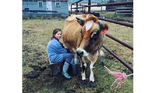 Daughter Madalynne milking *Belle*