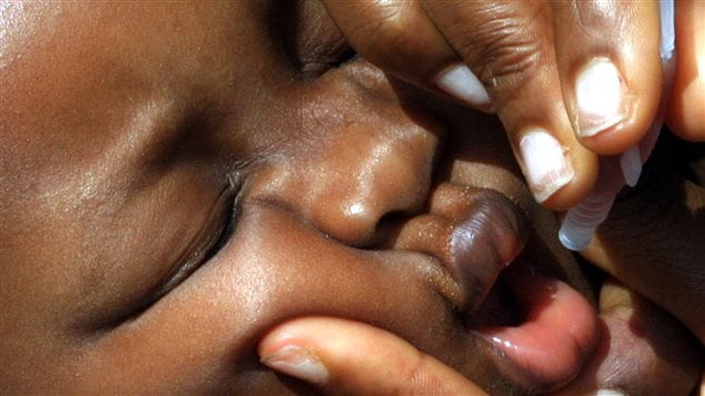  A baby receives a polio vaccine in the Agege area of Lagos in southwest Nigeria September 16, 2005.