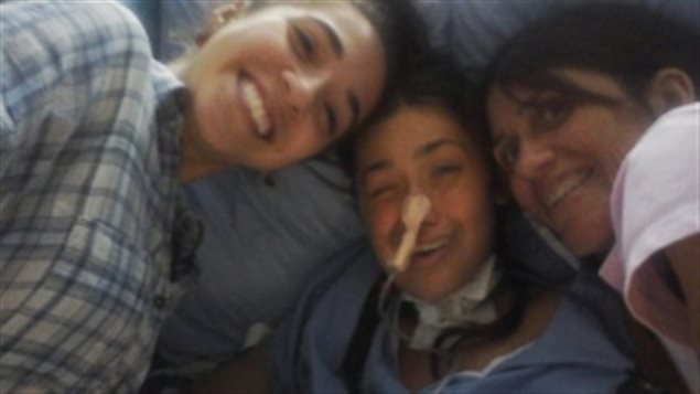 Lucila Munaretto (centre) woke up after her coma flanked by her roommate Emilie Siqueira (left) and her mother Alicia.