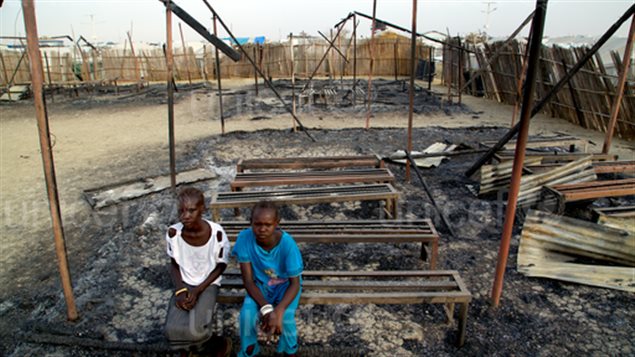 On 3 March 2016 in South Sudan, Chubat (right), 12, sits with her friend in the burned ruins of her school in Malakal Protection of Civilian site. The UNICEF supported primary school was burnt down in fighting on 17-18 February 2016, that left at least 18 people dead. 470 children attended grades 1 through 6. The school had five classrooms and seven teachers