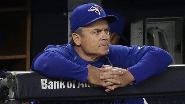 Blue Jays manager John Gibbons tries to stay calm at Yankee Stadium on Tuesday. As he ponders his club's messy start, Gibbons must also grapple with a vote of confidence he received from management last week. A vote of confidence can many times lead to a manager looking for work. We see Gibbons with something of a scowl on his face as he looks out to the field from the dugout. He is dressed in Jays blue from head to toe and has fingers interlocked as he leans forward with both arms on the dugout rail. We have no idea what he's looking at, but, likely, it is not pretty.
