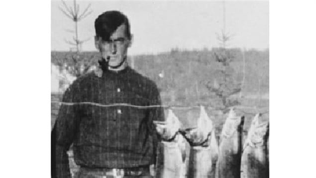 Thomson with fish at Canoe Lake, 1914