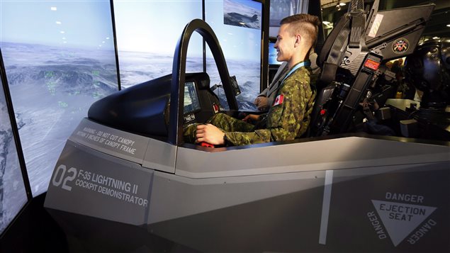  Canadian Forces member Pte. Jean-Christophe Sherrer tries out an F35 Lightning ll flight demonstrator at the CANSEC 2016 expo, Thursday, May 26, 2016, in Ottawa. 