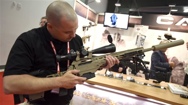  Patrice Picard shows off a CADEX sniper rifle at the Canadian Association of Defence and Security Industries’ CANSEC trade show in Ottawa on Wednesday, May 27, 2015.