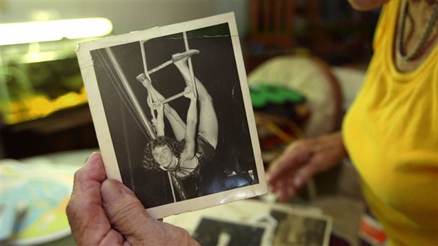Thelma Kemp holds a photo of herself when she was a star aerialist 