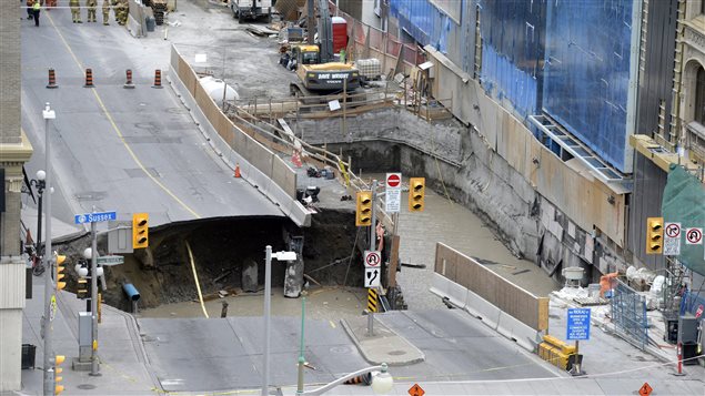 Water rushed into the gaping hole left after a road collapsed in downtown Ottawa.