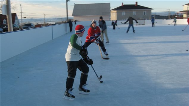 Hockey historian Andrew Caddell (centre) played hockey with his son Jack in Kamouraska, Quebec in December 2006.