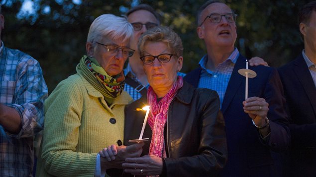 Ontario premier, Kathleen Wynne (centre) attended the Toronto vigil with her partner Jane Rounthwaite.