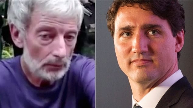 Prime Minister Justin Trudeau, right, says Canada is committed to bringing those responsible for the murders of Canadians Robert Hall, left, to justice "however long it takes."  directly at the camera with something of a determined look in his eyes. We see the forlorn face of Hall on the left. His grey hair is thinning. He wears a blue tee-shirt and is looking down toward the ground. The prime minister is dark jacket and tie wearing a determined look on his face.