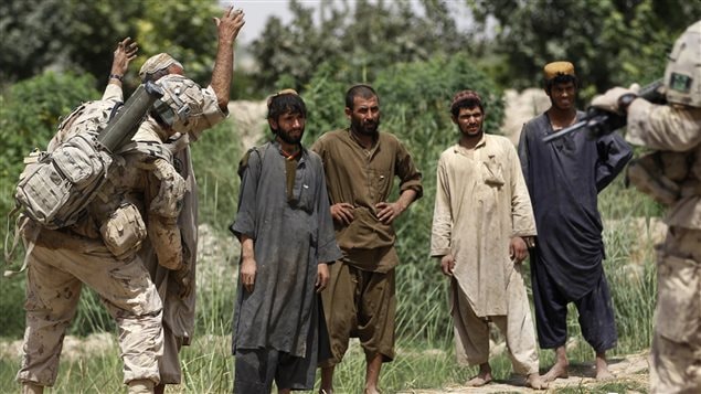  Soldiers with the Canadian Army’s 1st Battalion, The Royal Canadian Regiment Battle Group, search a group of men working in the grape fields near the village of Bazaar e Panjwaii, in the Panjwaii district of Kandahar province August 9, 2010.