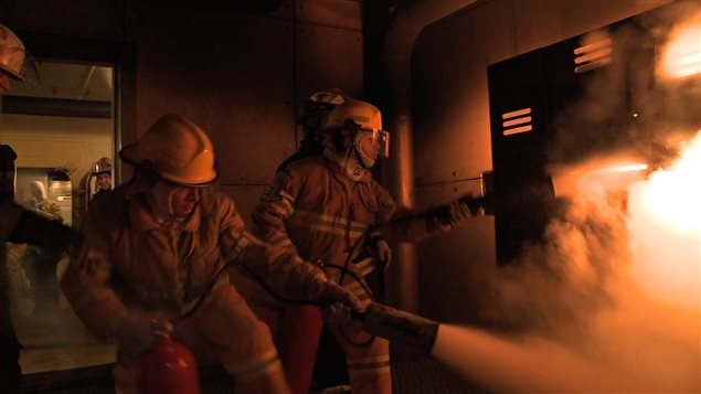 Two astronaut candidates taking part in a fire rescue exercise. (Credit: Canadian Space Agency)
