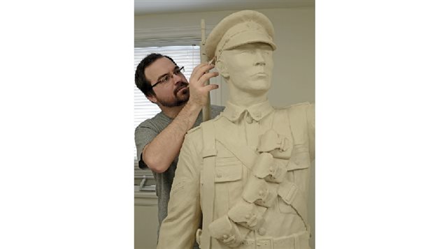 Showing scale, artist Tyler Fauvelle sculpts the Sergeant Francis Pegahmagabow figure for the three-metre bronze statue that honours Canada’s most decorated Aboriginal war hero.