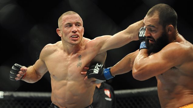  Nov 16, 2013; Las Vegas, NV, USA; Georges St-Pierre (left) fights against Johny Hendricks (right) in their welterweight championship bout during UFC 167 at MGM Grand Garden Arena.