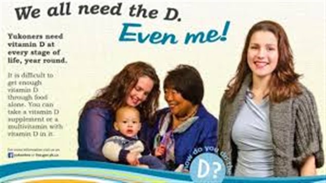 Research reveals that--likely--we all don't need that extra supplement of Vitamin D to stay healthy. We see what appears to be a print ad. It contains three women, one, a healthy woman of perhaps 30 with lovely brown hair, stands on the right. To her right, stands an aboriginal woman and a young woman with brown hair, both smiling at a baby that the woman on the far left of the picture is holding a baby in her right arm. The headline on the ad reads, "We all need D. Even 