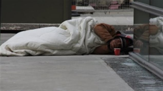 A homeless man lies on the street in Toronto, Ontario, Canada’s biggest city in January 2015 where 2 others died of exposure to cold. Many of the homeless die alone and lonely. A unique new programme seeks to provide some emotional comfort in their final days