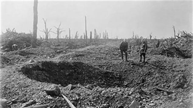 Inspecting shell craters in the blasted landscape along the road to Bapaume, the Somme 1916