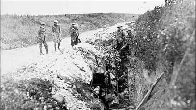 The original caption says this is the St John’s Road reserve area located about 200 metres behind the front lines. The caption says soldiers waiting ’before the attack’, but is it before or sometime after the attack? Are the men lying in the trench sleeping or dead?