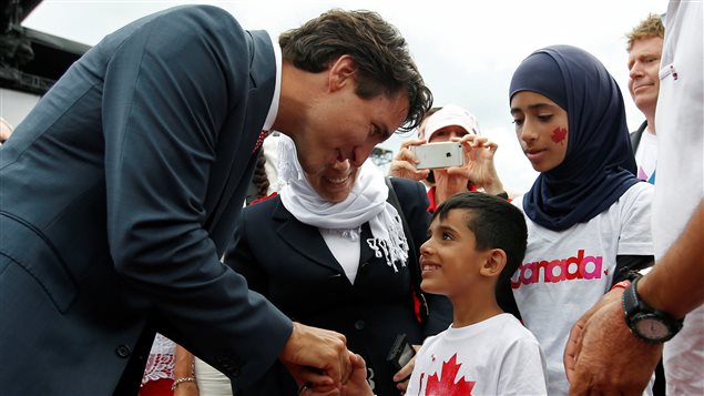  Canada’s Prime Minister Justin Trudeau shakes hands with a Syrian refugee during Canada Day celebrations on Parliament Hill in Ottawa, Ontario, Canada, July 1, 2016.