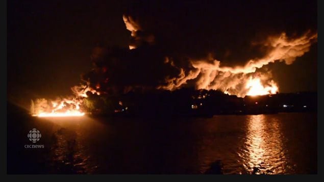 Another view of the giant fire from the dozens of burning oil cars, each with over 100-thousand litres of highly flammable Bakken crude. It was the fourth deadliest fire in Canadian railway history
