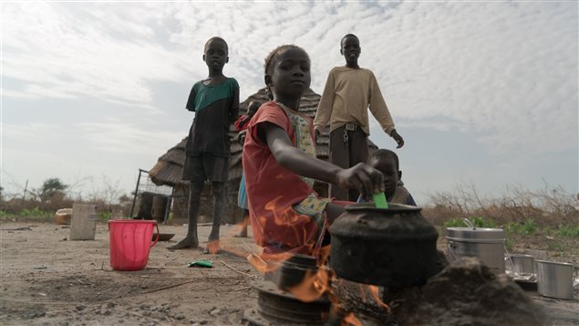 Five-year-old Nyaching helps prepare lunch for the family. This is often the only meal they will eat in a day. 