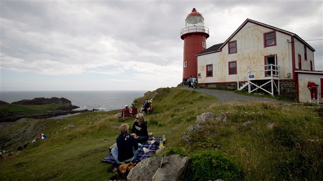  Picnickers take in the view as they sit on the grass outside the Ferryland lighthouse in Ferryland, N.L., Thursday, August, 8, 2013. 