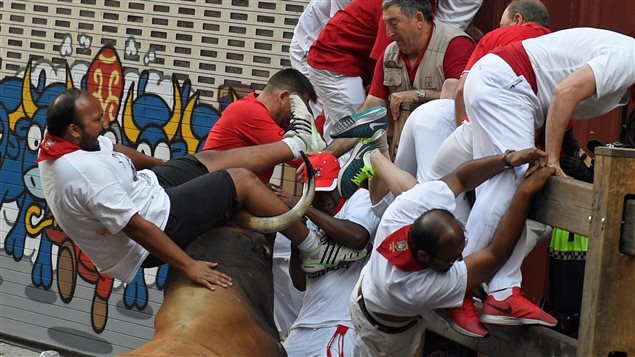  A runner is thrown by a Cebada Gago fighting bull at the Estafeta corner during the second running of the bulls at the San Fermin festival in Pamplona, northern Spain July 8, 2016. 