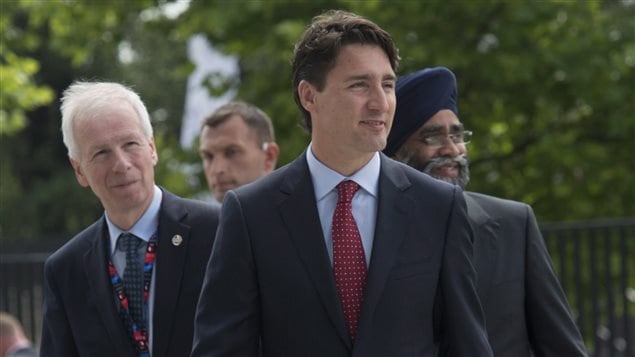  Canadian Prime Minister Justin Trudeau arrives with Foreign Affairs Minister Stephane Dion and Minister of National Defence Minister Harjit Sajjan at the NATO summit in Warsaw, Friday July 8, 2016. 