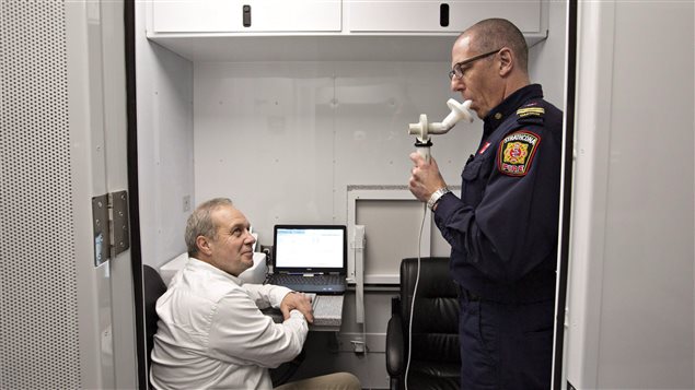 Dr. Jeremy Beach tested the lung function of firefighter captain Kelly Lehr after the Fort McMurray wildfire.