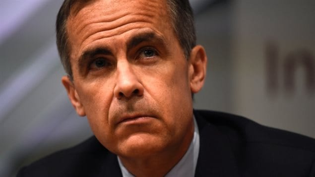 Mark Carney is meeting with financial and business leaders around the world to develop a plan to deal with--among other things--a low-carbon global economy. We see a closeup (the Cockneys call if a "full boat") of the face of a handsome man with a slight tan and short dark hair. His brow is furrowed and he has a serious expression on his face.