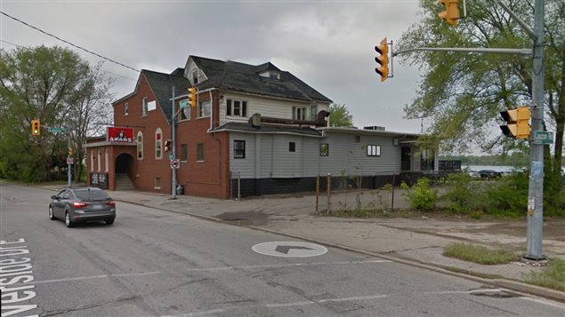 Abars, probably summer 2015 before being locked up. The brick fron was added sometime ibefore 2000, but the original building still visible with lookout windows on the upper floor to watch for approaching police raids.