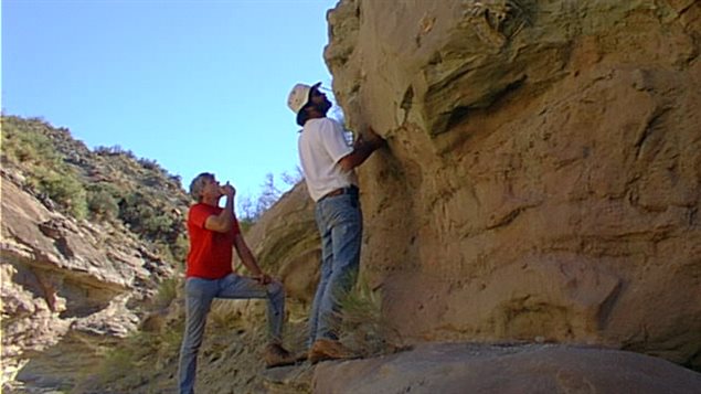 Professors Currie and Corria on the cliff face near Sierra Barrosa where the fossil was found originally in 2000.