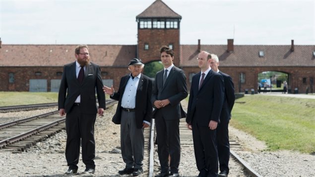 Canada’s Prime Minister during a recent emotional visit to Auschwitz death camp after the NATO meeting earlier this month. L-R: Dr. Piotr Cywinski, Nate Leipciger (Auschwitz survivor), Prime Minister Justin Trudeau, Rabbi Adam Scheier, adn partially hidden, Foreign Affairs Minister Stéphane Dion