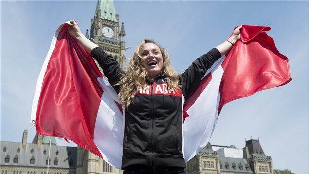  Canadian athlete Rosie MacLennan holds a Canadian flag after being named as the flag bearer for the upcoming Summer Olympics Thursday July 21, 2016 in Ottawa.