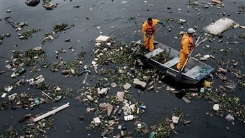 An Associated Press investigation found athletes in the 2016 Rio Olympics will be swimming and boating in waters so contaminated with human feces that they risk becoming violently ill and unable to compete in the Games. We see two men in a small boat surrounded by water filled with debris, which they are attempting to clean up.