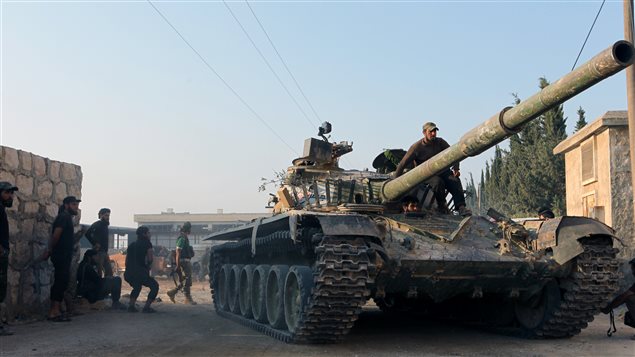 مقاتلون معارضون لنظام الرئيس السوري بشار الأسد بعد دخولهم كلية المدفعية على تلة الراموسة جنوب مدينة حلب يوم أمس الأول.