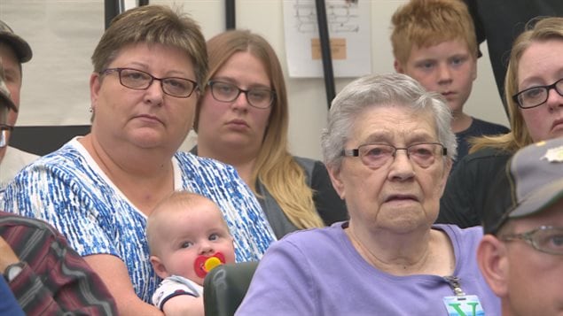 In June, about 60 people crammed into a room at the Saskatchewan legislature to voice their concerns over the proposed Yancoal potash mine near Southey. We see a shot of people of all ages (from a baby to senior citizens) looking straight ahead. They have the air of people who are being lectured to. The women wear mainly blue, most are wearing glasses.