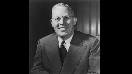 I'm with former U.S chief justice Earl Warren when it comes to sports. We see a white-haired man in an old-fashioned grey suit with wide lapels smiling at us in a posed photo.