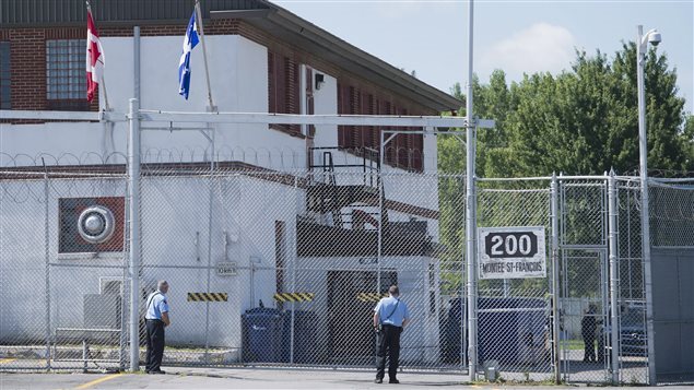 Des gardiens devant le Centre de surveillance de l’immigration de Laval lundi 15 août. © PC/Graham Hughes